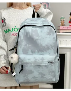 Detailed view of Korean style tie-dye backpack showing front pocket and plush charm.