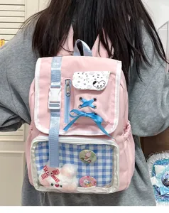 Detailed view of sweet Japanese style pink backpack with clear pocket cute badges and bows