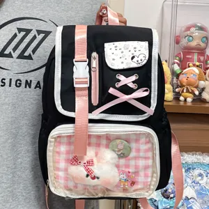Japanese style black and pink ita backpack with clear window, cute ribbon and plush bunny charm.