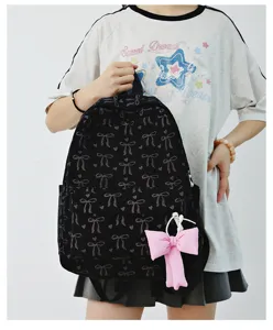 Japanese style black corduroy backpack for women featuring cute bow patterns and pink pendant.