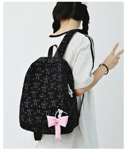 Japanese ins-style canvas backpack with cute bow print and pink pendant for women and girls.