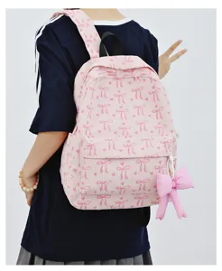 Cute pink corduroy backpack with bow print and pendant, stylish school bag for women and girls.