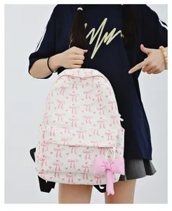Detailed shot of the Japanese sweet style corduroy backpack with pink bow print and pendant.