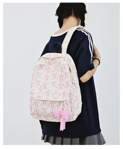 Sweet pink bow corduroy backpack detail view showing soft fabric texture and cute pendant.
