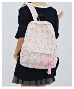 Corduroy backpack detail shot featuring pink bow pattern and cute hanging pendant design.