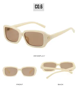 Detailed view of fashionable white square sunglasses featuring brown lenses and sleek frame.