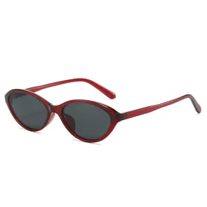 Trendy retro cat eye sunglasses for men and women featuring red frame and dark lenses.
