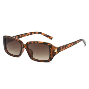 Stylish rectangle sunglasses with chic tortoiseshell frame gradient lenses and gold floral temple detail.