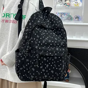 Black corduroy backpack for women, lightweight school bag with cute heart and bow patterns.