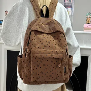 Cute brown corduroy backpack for women, casual school bookbag with heart and bow prints.