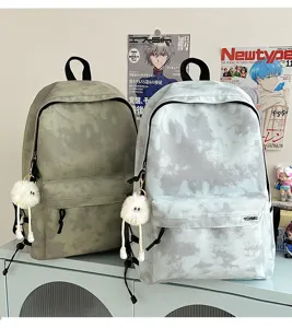 Korean style tie-dye canvas school backpack with cute plush pendant for daily use.