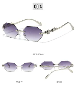 Detail view of rimless gradient purple polygon sunglasses featuring rhinestone snake temples.