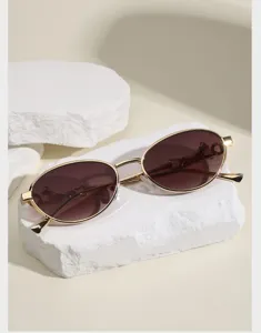 Oval metal sunglasses with vintage animal motif gold frame brown lenses trendy fashion eyewear