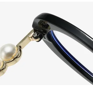 Close-up of black glasses frame with gold hinge and pearl detail, stylish anti-blue light design.