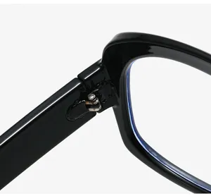 Close-up detail of black eyeglasses frame hinge and metal screw structure, clear optical view.