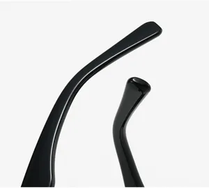 Close-up detail of smooth black eyeglass temples, showing polished surface and curved tips.