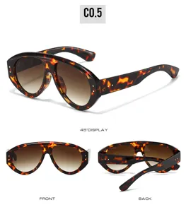 Detail view of oversized tortoise shell sunglasses with gradient brown lenses and wrap style.