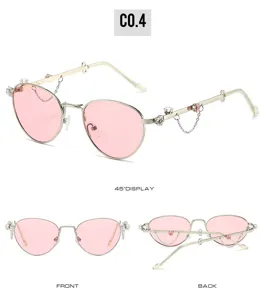 Occhiali da sole ovali rosa in metallo con strass e catenelle per donne alla moda.