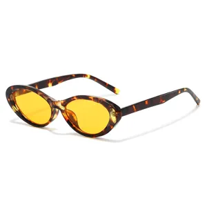 Vintage chic oval cat-eye sunglasses with tortoiseshell frame and striking yellow lenses.
