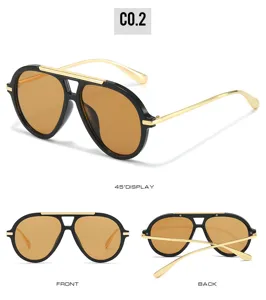 Classic aviator sunglasses detail showing black frame, gold metal temples and brown lenses.