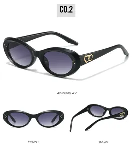 Detailed view of trendy oval cat-eye sunglasses with charming double heart metal decor.
