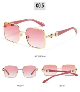 Stylish square gradient pink sunglasses with golden metal frame and chic snake temples.