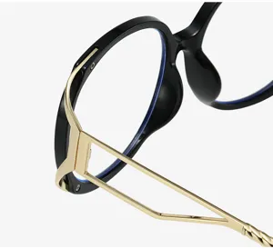 Close-up detail of stylish black cat-eye optical glasses frame with sleek gold metal temples.