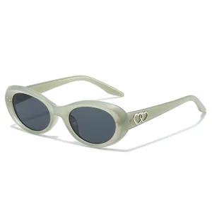 Trendy oval cat-eye sunglasses for men and women with chic double heart temple decor.