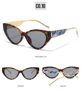 European style cat-eye sunglasses with tortoise frame, gold temples and blue floral detail.