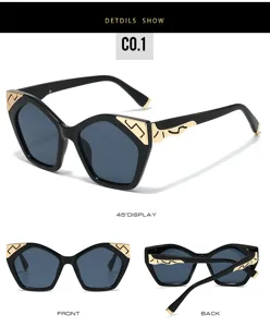 Chic black cat eye sunglasses with unique gold metal corner details, ideal for outdoor street style.