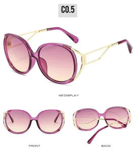 Women's oversized oval fashion sunglasses with purple gradient lenses and gold metal temples.