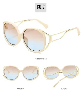 Detailed view of oversized oval fashion sunglasses with gradient lenses and metal temples.