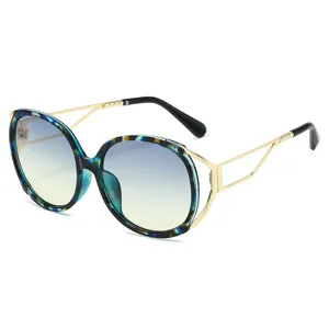Oversized round oval fashion sunglasses for women, gradient lenses with blue tortoise frame.