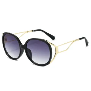 Oversized oval fashion sunglasses for women, gradient lenses with metal geometric temples.