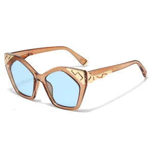 Fashion cat eye sunglasses for women with trendy blue lenses and gold metal details outdoors.