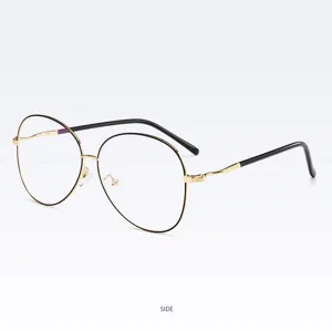 Metal oval optical glasses frame side detail view showing slim gold rim and black temple.