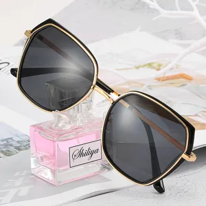 Fashion black and gold polygonal polarized sunglasses for women, stylish oversized UV400 shades.