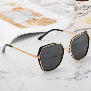 Women's stylish polygon sunglasses with gold and black frame, perfect fashion eyewear.