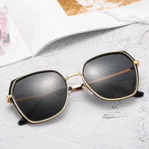 Stylish women's polygon sunglasses featuring a chic gold metal frame and dark lenses for daily wear.