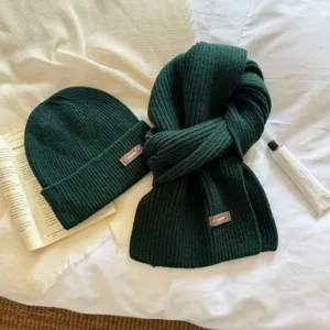 Dark green knitted beanie and scarf set, thick and warm winter two-piece accessory for women.