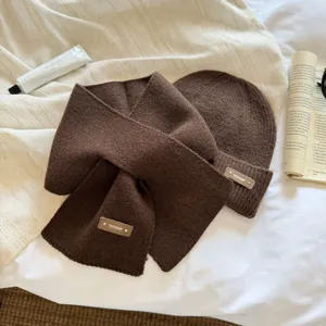 Cozy brown knit scarf and beanie hat set detail, soft woolen material for autumn and winter warmth.