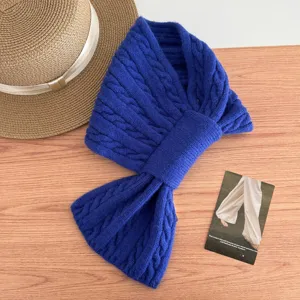 Blue cable knit winter scarf detail view, cozy thermal cross muffler for cold weather wear.