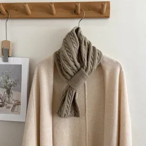 Cozy cable knit winter scarf for women, elegant crossover design, warm and stylish neck warmer.