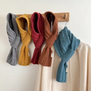 Cozy cable knit cross scarf for women, warm winter neckerchief in multiple solid colors.