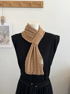 Cozy cable knit winter scarf for women, solid color cross neck warmer fashion accessory.