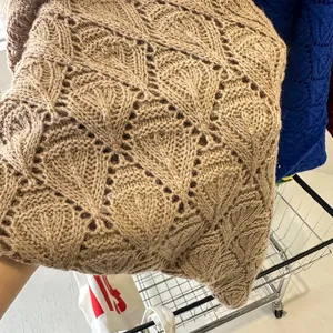 Brown knit hollow shawl detail, soft texture and elegant design for spring and autumn daily wear.