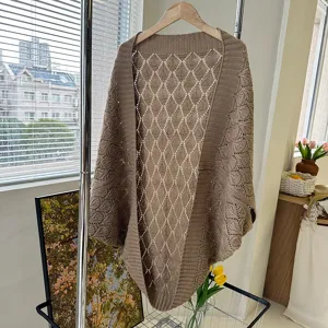 Detailed view of the brown knitted hollow rhombus shawl, showing delicate texture and weave.