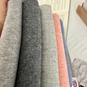 Detailed view of soft wool and cashmere blend scarf fabric rolls in multiple stylish autumn colors.