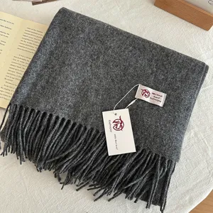 Dark grey wool scarf detail, soft cashmere texture, neat fringes and brand tag shown.