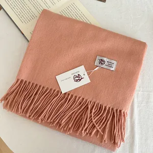 Close-up detail of the warm solid color thick wool scarf featuring elegant fringe design.